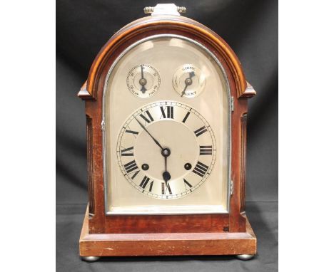 An early 20th century mahogany veneered domed top bracket clock, the silvered dial with subsidiary regulator and chime/silent