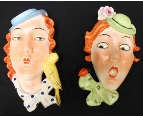 Two Art Deco ceramic wall masks of ladies wearing hats. Largest measures approximately 24cm high.