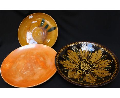 A large Carltonware orange lustre bowl, together with two slip ware dishes. (3)