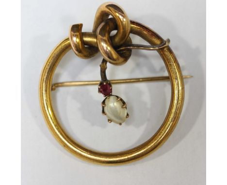 A 14ct gold ruby and pearl brooch, of circular form with central suspended pearl and ruby drop. Approx 4 grams.