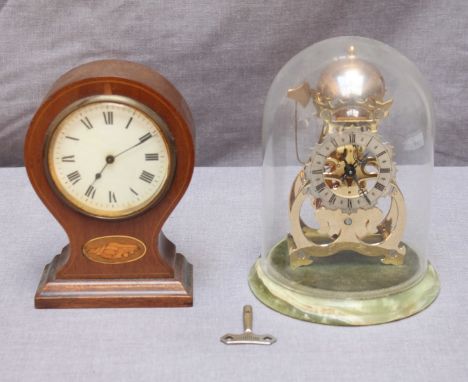 An Edwardian mahogany balloon clock with white enamel dial, together with a modern skeleton clock under a  dome. (2)
