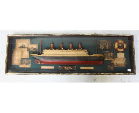 A large contemporary Titanic framed presentation box frame, with a model of the ship and various printed cuttings.