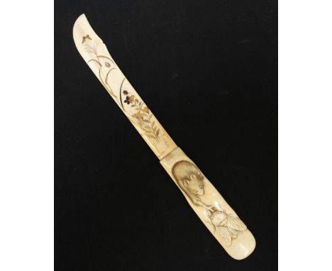 A late 19th century Japanese carved ivory paper knife, the blade painted in gilt with leaves, flowers and insects, the handle