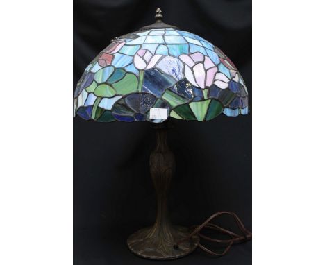 A Tiffany style leaded glass table lamp, the shade decorated with coloured flowers with a moulded base.