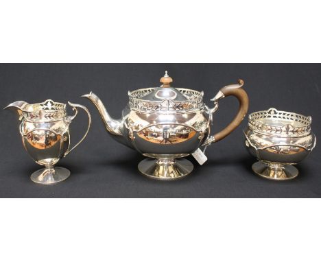 A George V three-piece silver tea set of globular form with pierced rim, paneled body raised on circular spreading foot, comp