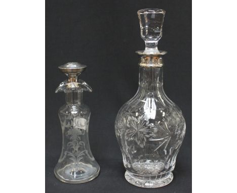 A modern silver topped cut glass decanter and stopper, together with a smaller glass decanter with silver stopper. (2)
