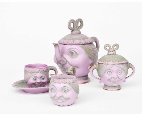 A Shafer and Vater Suffragette bisque porcelain tea service, each piece modelled as a head of a woman, comprising teapot and 