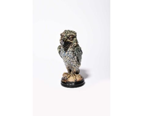 A Martin Brothers stoneware bird jar and cover by Robert Wallace Martin, dated 1914, modelled standing with claw feet, wings 