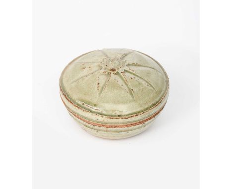 Φ Richard Batterham (1936-2021)a stoneware circular pot and cover, the top with cut star motif, covered in an ash glaze with 