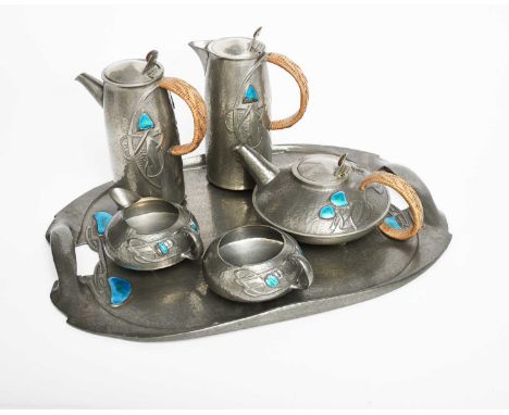 A Liberty & Co Tudric pewter and enamel tea set designed by Archibald Knox, model no. 0231, cast in low relief with Art Nouve