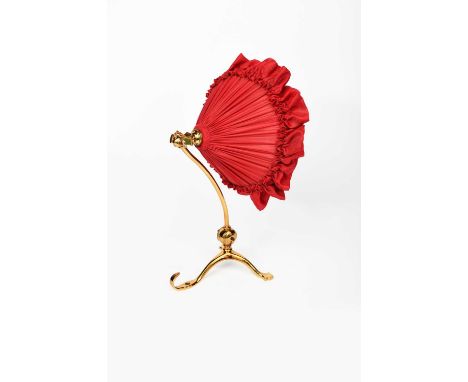 A WAS Benson brass desk/wall light, tripod foot with curved, articulated stem and fitting, with red silk shade stamped marks,