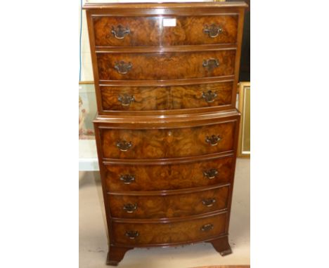 A reproduction walnut dwarf chest on chest with 7 drawers, on bracket feet
