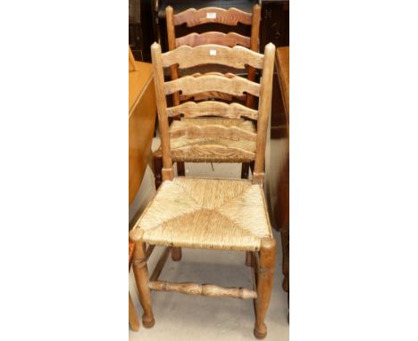 A set of 4 19th century elm ladder back rush seat dining chairs; a pair of wheel back chairs