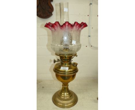 A Victorian style brass oil lamp and shade