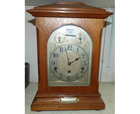 A 1920's oak cased mantel clock, 8 day chiming and striking movement