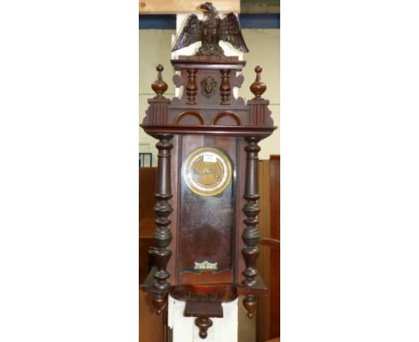 A 19th century Vienna walnut wall clock with eagle finial and striking spring driven movement
