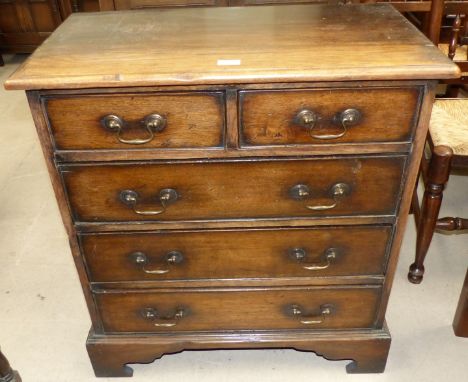 A dwarf distressed oak crossbanded chest of 2 long and 2 short drawers, with brass swan neck handles and bracket feet, width 