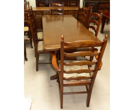 A period style oak dining suite comprising refectory table on stretcher and peg supports, 6 (4 + 2) ladder back dining chairs