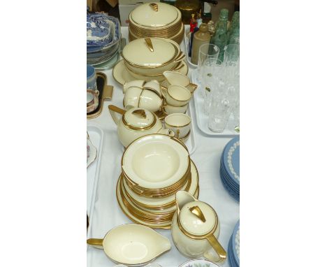 An Art Deco Wedgwood & Co ivory dinner and tea service with green and gilt border