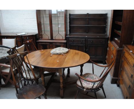 An Ercol dresser with boarded plate rack, four Ercol stick back chairs, a side cabinet and a dropleaf table (7).