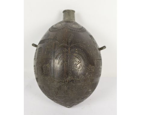 A 19th century carved "Bugbear" powder flask decorated with figures and dwellings in a landscape 'P. Bulger, Erin Go Bragh', 