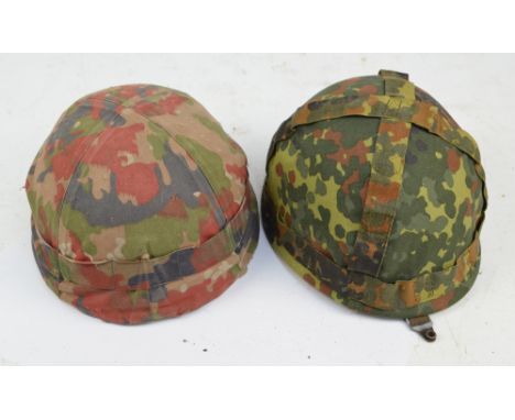 A WWII helmet with leather liner and chin guard, also a further helmet with leather liner, both with camouflage covers.