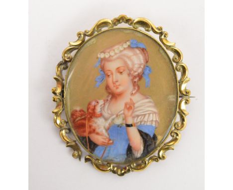 A 19th century oval ivory miniature portrait depicting a young woman with a dog holding a dog, 5.5 x 4.5cm, within a cast fol