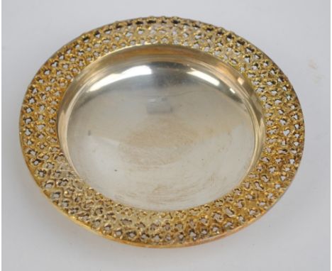 STUART DEVLIN; an Elizabeth II hallmarked silver gilt circular pin dish with cast and pierced broad rim, London 1972, diamete