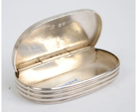 WILLIAM SUMMERS; a Victorian hallmarked silver oval push action snuff box with fluted decoration and match striker to the sid