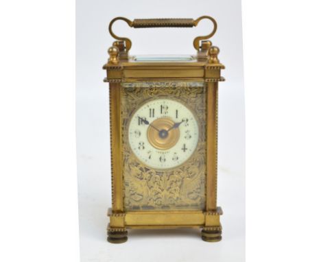 A late 19th century brass carriage clock with bead decorated edges and handle, engraved 'W.F.G. 26 April 1918 Warby' to the t