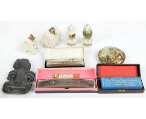 A mixed collectors' lot comprising three boxed mouth organs including an example by Hohner, four pieces of Crested Ware inclu