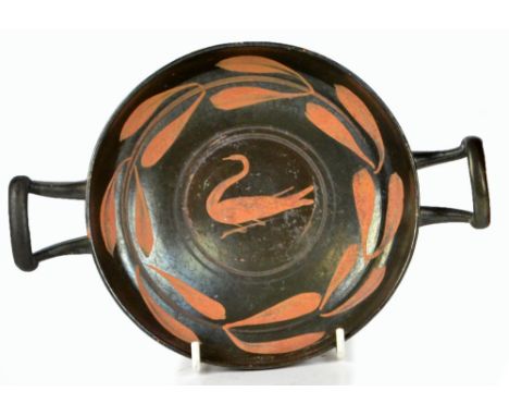 A Greek campanian kylix, the interior centred with a bird within a leaf decorated border, c.335 B.C., width 25.5cm.   CONDITI