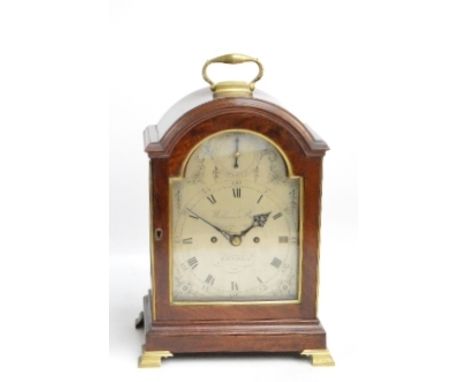 **AMENDED DESCRIPTION** A George III mahogany bracket clock with brass swing loop carrying handle above domed case, arched si