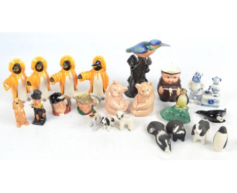 A collection of figurines including four John Beswick penguins (one af), pair of Poole bears, two small Royal Doulton charact