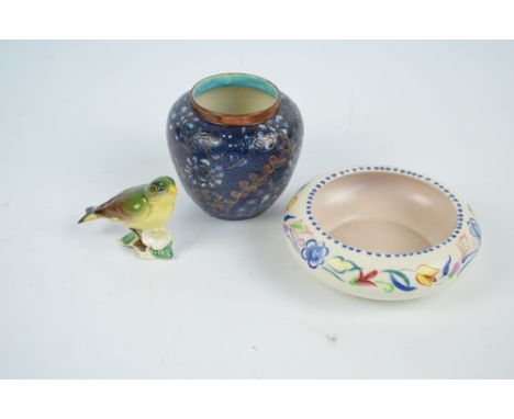 A Poole Pottery squat form bowl, a Doulton Lambeth Slater's Patent vase with blue ground and bronzed gilt decoration, and a B