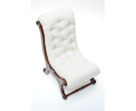 A late 19th century mahogany button back slipper chair, with scrolling legs to turned stretchers.