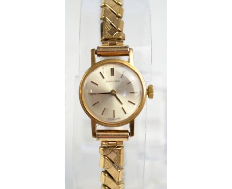 LONGINES; a lady's vintage 9ct gold cased wristwatch, the circular dial set with gold batons and adjustable strap, unboxed.