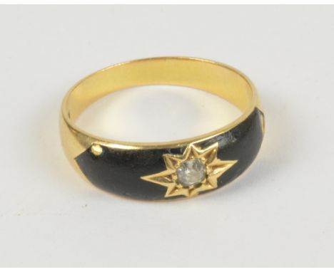 An 18ct yellow gold diamond and black enamel set mourning ring, with small central diamond within a star cut motif and black 