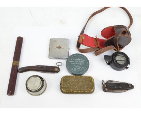 A military issued leather cased pocket compass, a knife and fork set, a pocket knife, etc.