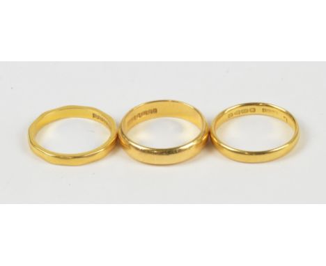 Three 22ct yellow gold wedding bands, one with chamfered edge, all three size K½, approx 10.4g (3).