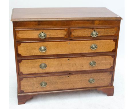 An early 19th century oak and mahogany crossbanded chest of two short and three long graduated drawers, raised on bracket fee