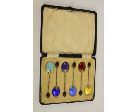 WILLIAM SUCKLING; a cased set of six George V hallmarked silver and enamel coffee bean spoons, each bowl decorated in a diffe