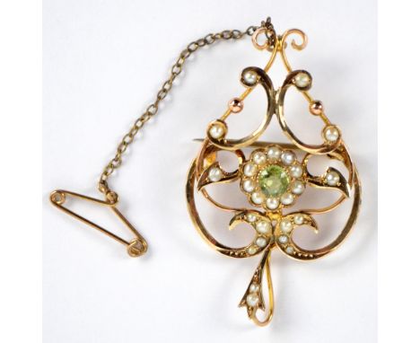 An early 20th century 9ct yellow gold brooch with scrolling heart decoration set with seed pearls and central circular perido