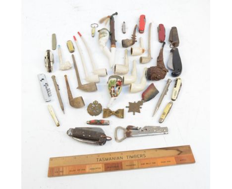 A collection of pipes including a carved wooden example, two transfer printed ceramic examples, a quantity of clay short and 