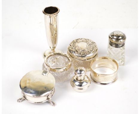 A quantity of mixed silver items to include a small trinket box, a repoussé cut glass pot, a napkin ring, a small bulbous pep