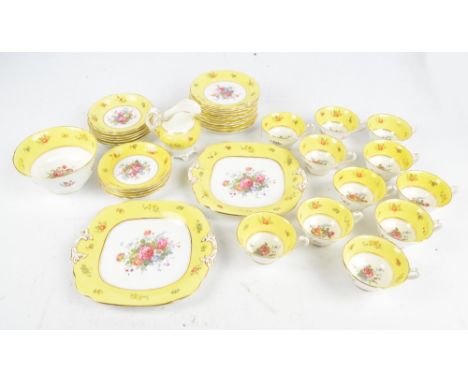 A part tea service of yellow and floral decorated 'Ye Olde English Grosvenor China', comprising two sandwich plates, twelve t