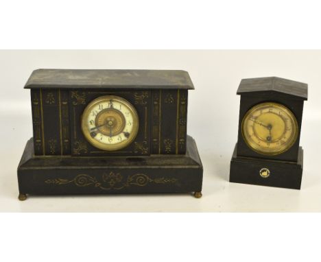 A late 19th century black slate mantel clock with dome top above circular two section dial set with Arabic numerals, on plint