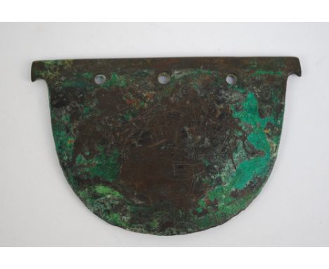 A bronze semi-circular shaving tool with three pierced holes, 10.5 x 7cm, probably 6th century. Purchased by the vendor from 