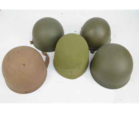 Four similar American helmets, with various liners, and a modern fibreglass hand made helmet (5).