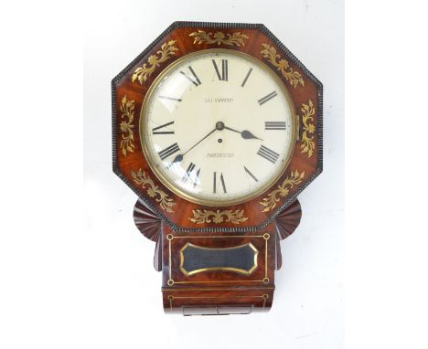 A 19th century mahogany brass inlaid wall clock with octagonal frame on fan shaped supports, the circular cream enamel dial s